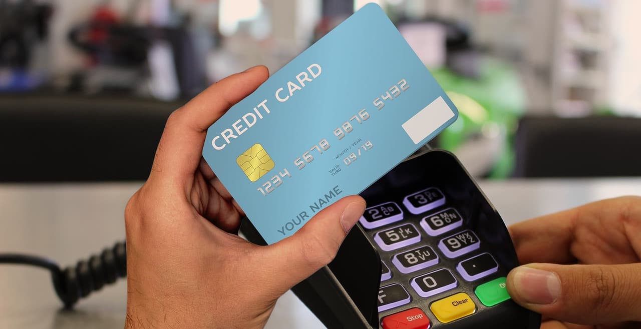 A customer tapping a card to pay at a checkout terminal